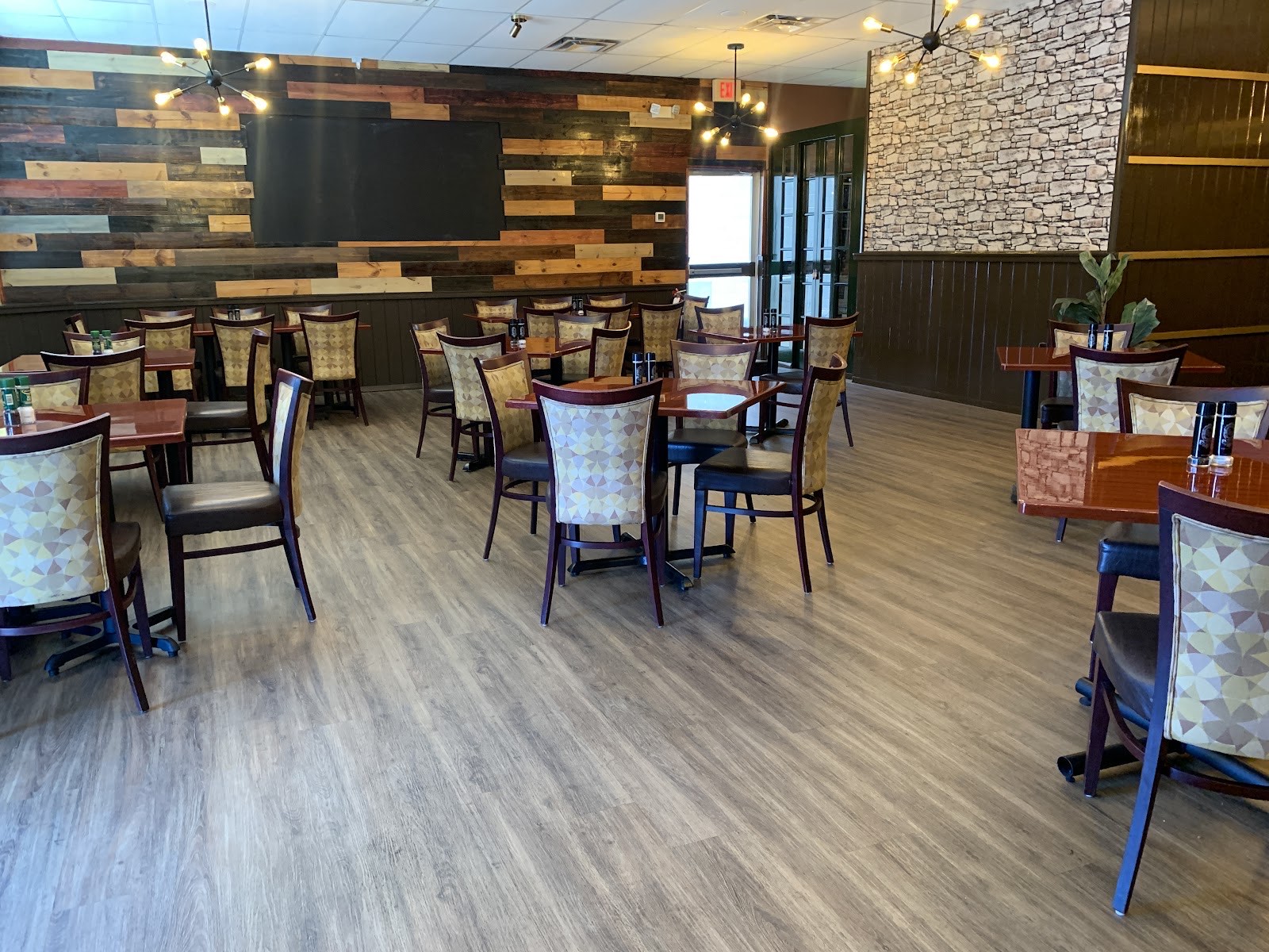 Bright open dining area with reclaimed-wood feature wall and stone accent